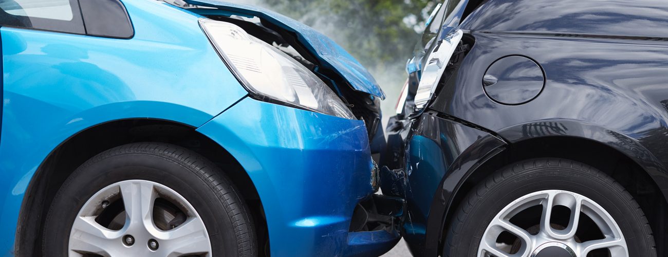 Close Up Of Two Cars Damaged In Road Traffic Accident